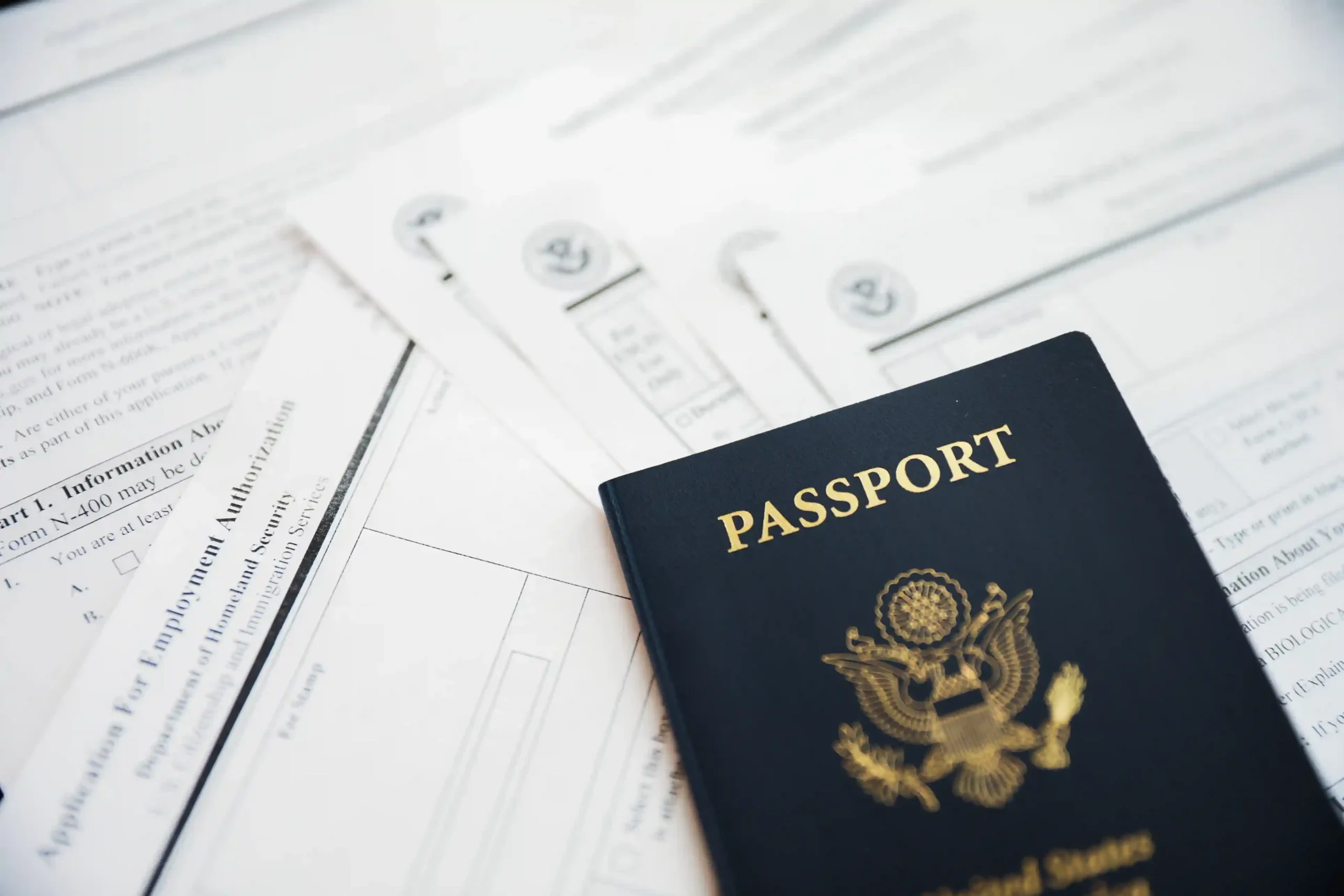 closeup-us-passport-with-immigration-visa-citizenship-travel-paperwork-wooden-tabl_11zon